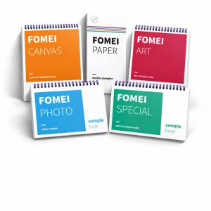 Five colorful spiral-bound books on white